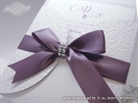 wedding invitation decorated with a purple satin ribbon